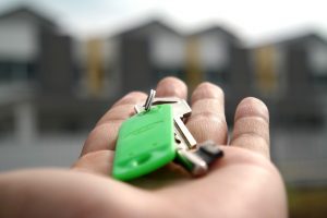 Person holding keys to new house