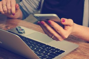 Employee using laptop and mobile phone